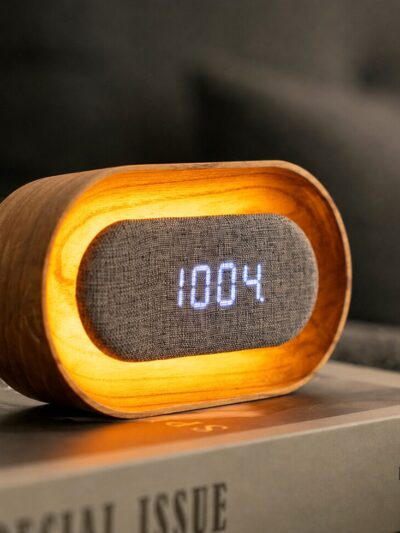 White ash alarm clock with floating display and warm glowing light.