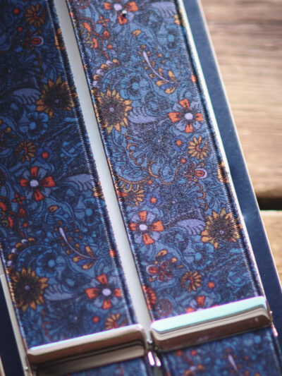 Close-up of a pair of men's braces in a blue floral pattern