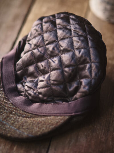 Quilted inner lining of a traditional brown flat cap