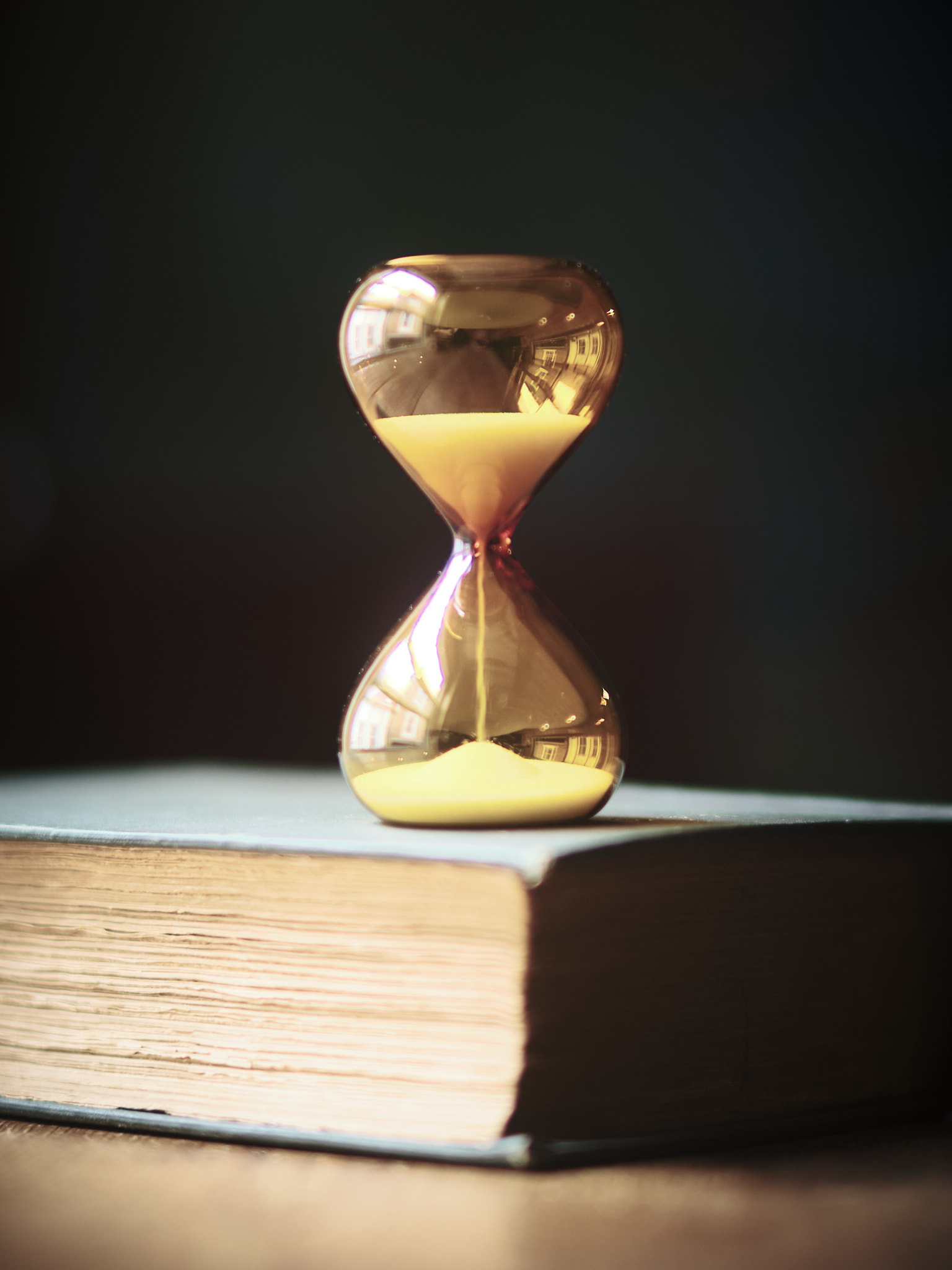 Modern contemporary sand timer hourglass in orange glass