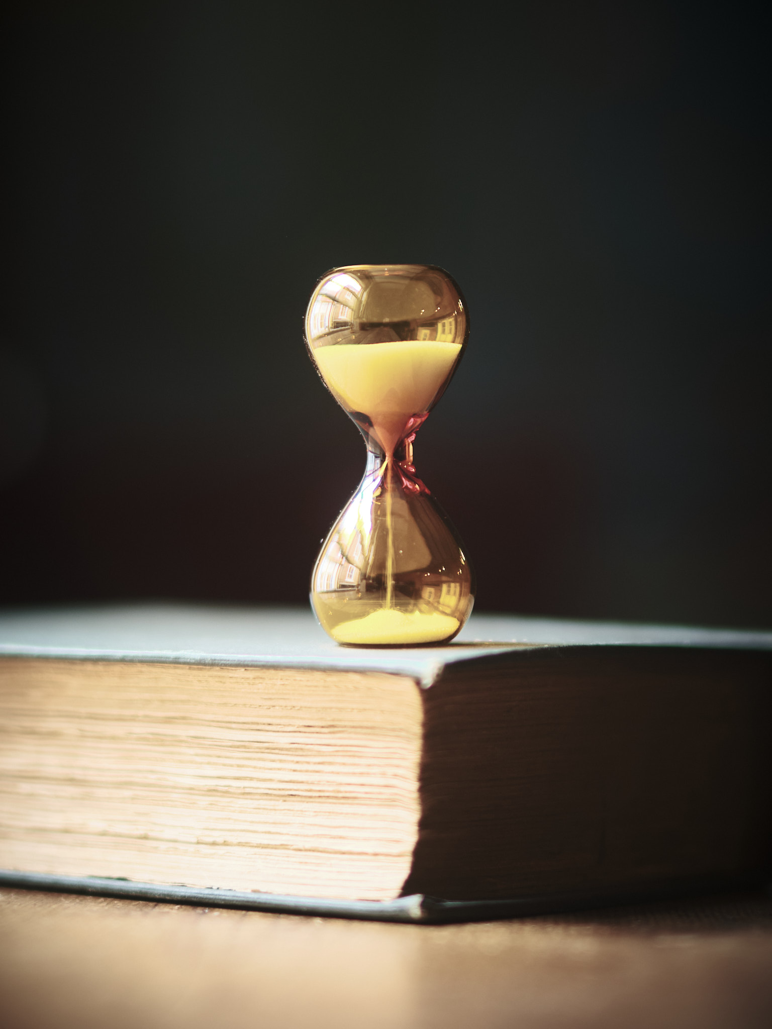 Modern contemporary sand timer hourglass in orange glass