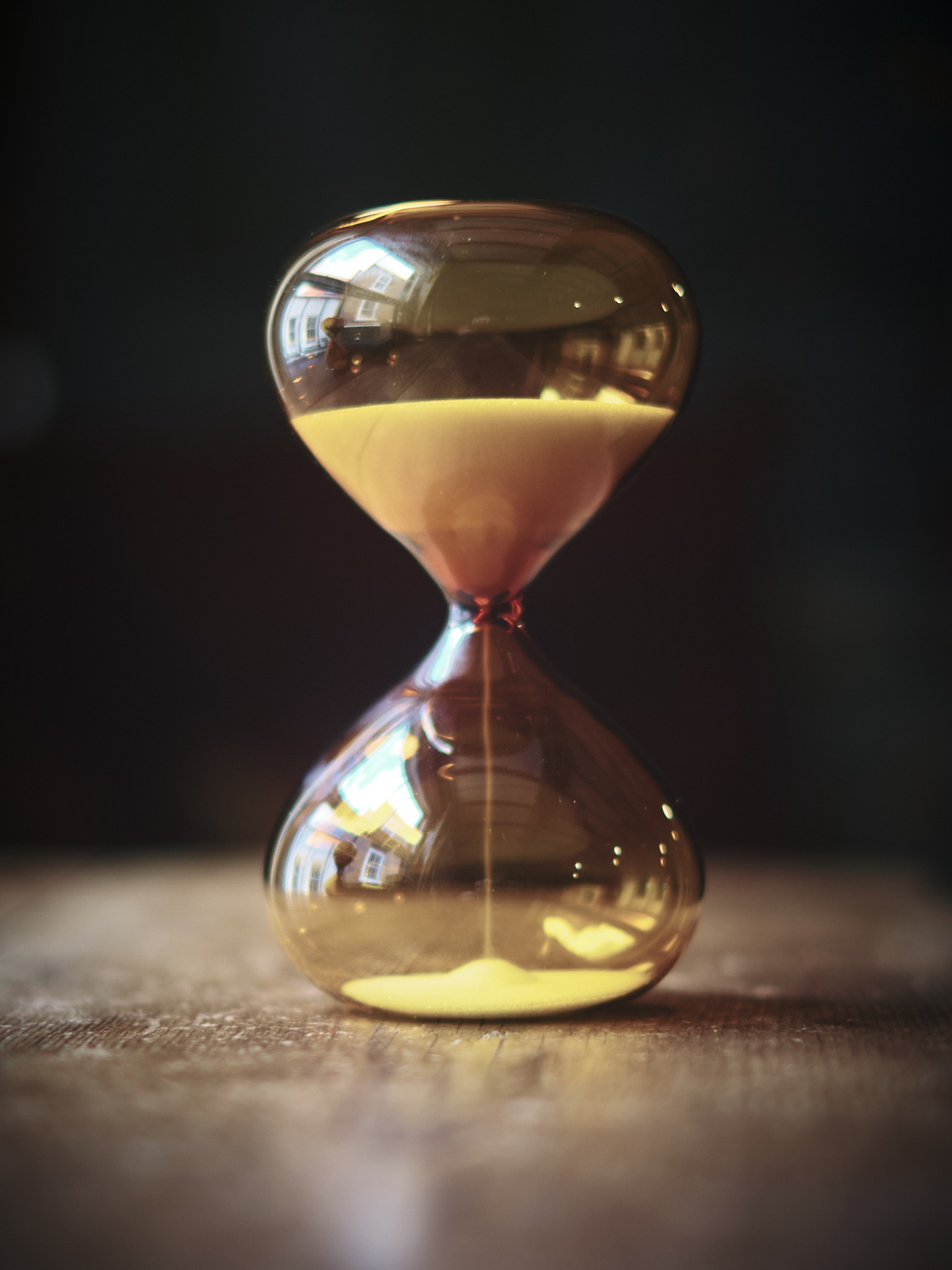 Modern contemporary sand timer hourglass in orange glass