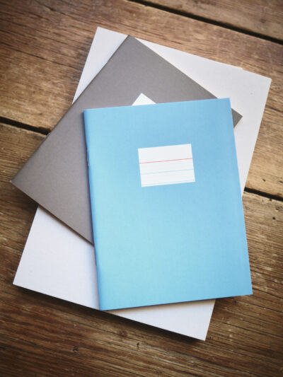 A stack of multicoloured contemporary notebooks